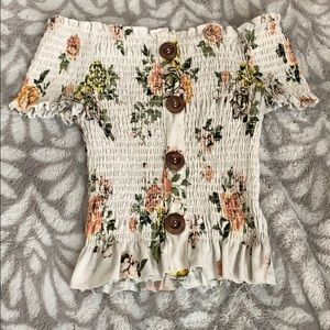 A flower off the shoulder crop top